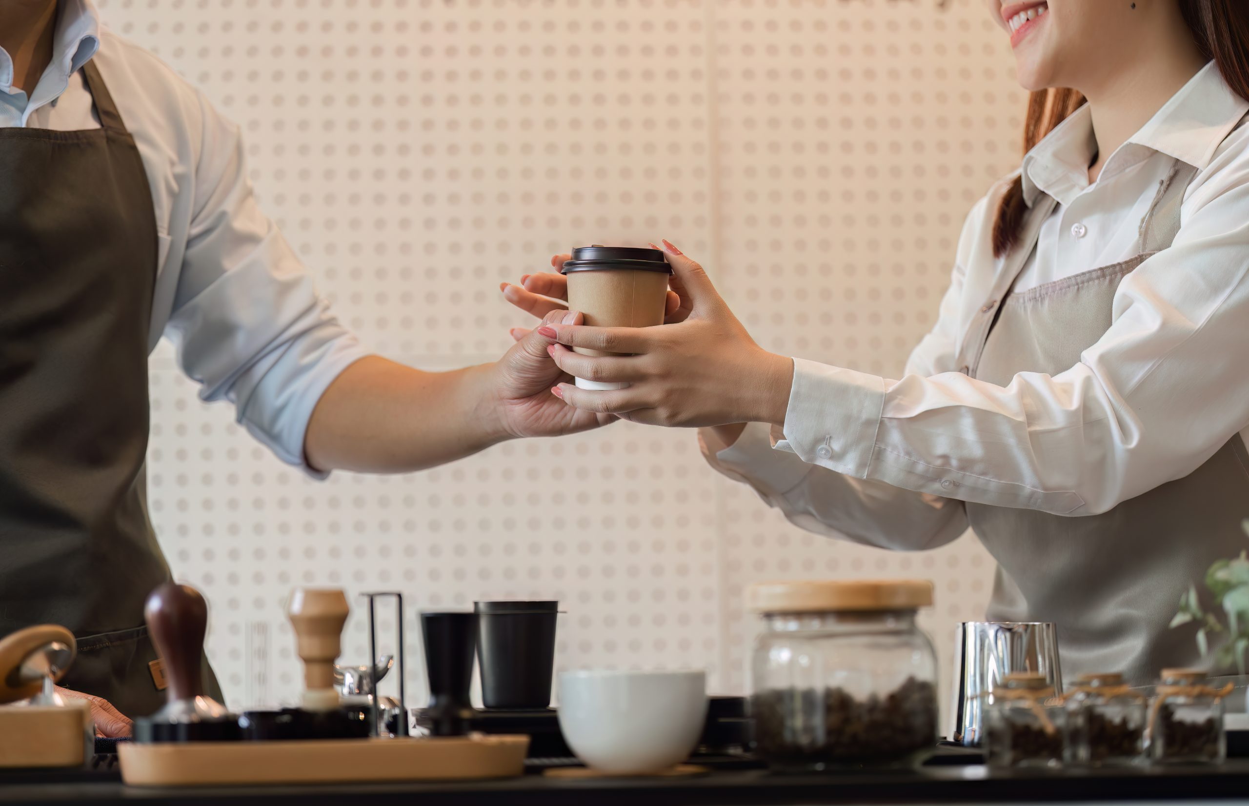 a barista hands a freshly prepared coffee to a cus 2025 08 27 05 54 56 utc 1 scaled