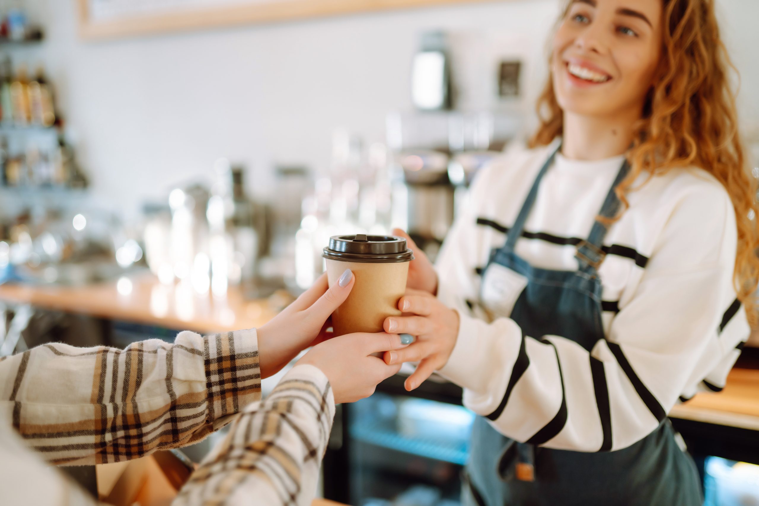 barista woman at coffee shop holding take away cof 2025 03 05 16 41 18 utc scaled