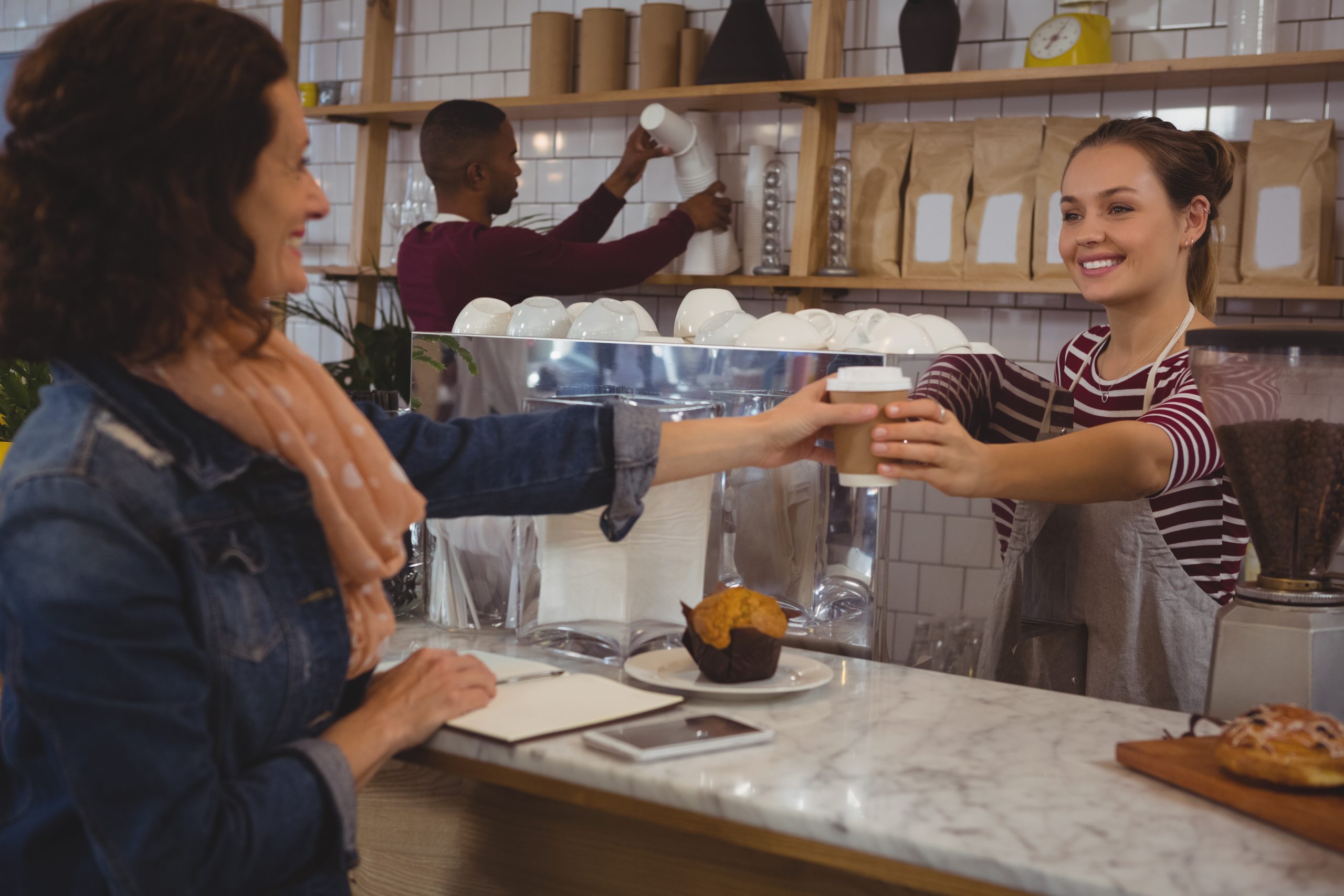 female owner serving coffee to customer 2025 04 04 23 53 38 utc scaled