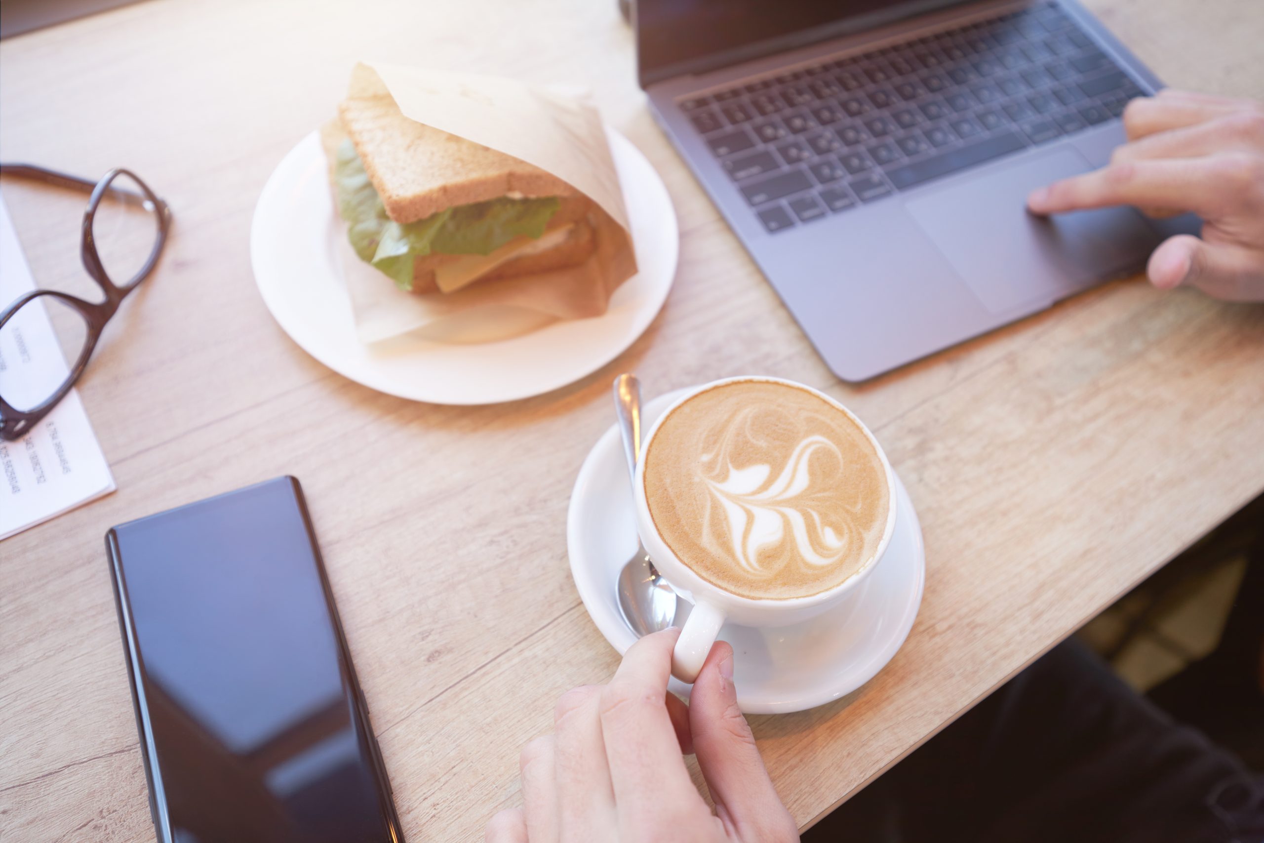 Affordable & Productive: Budget-Friendly Cafés for Remote Work 13 top view of a freelancer or businessman using lapt 2025 03 13 07 11 55 utc 1 scaled