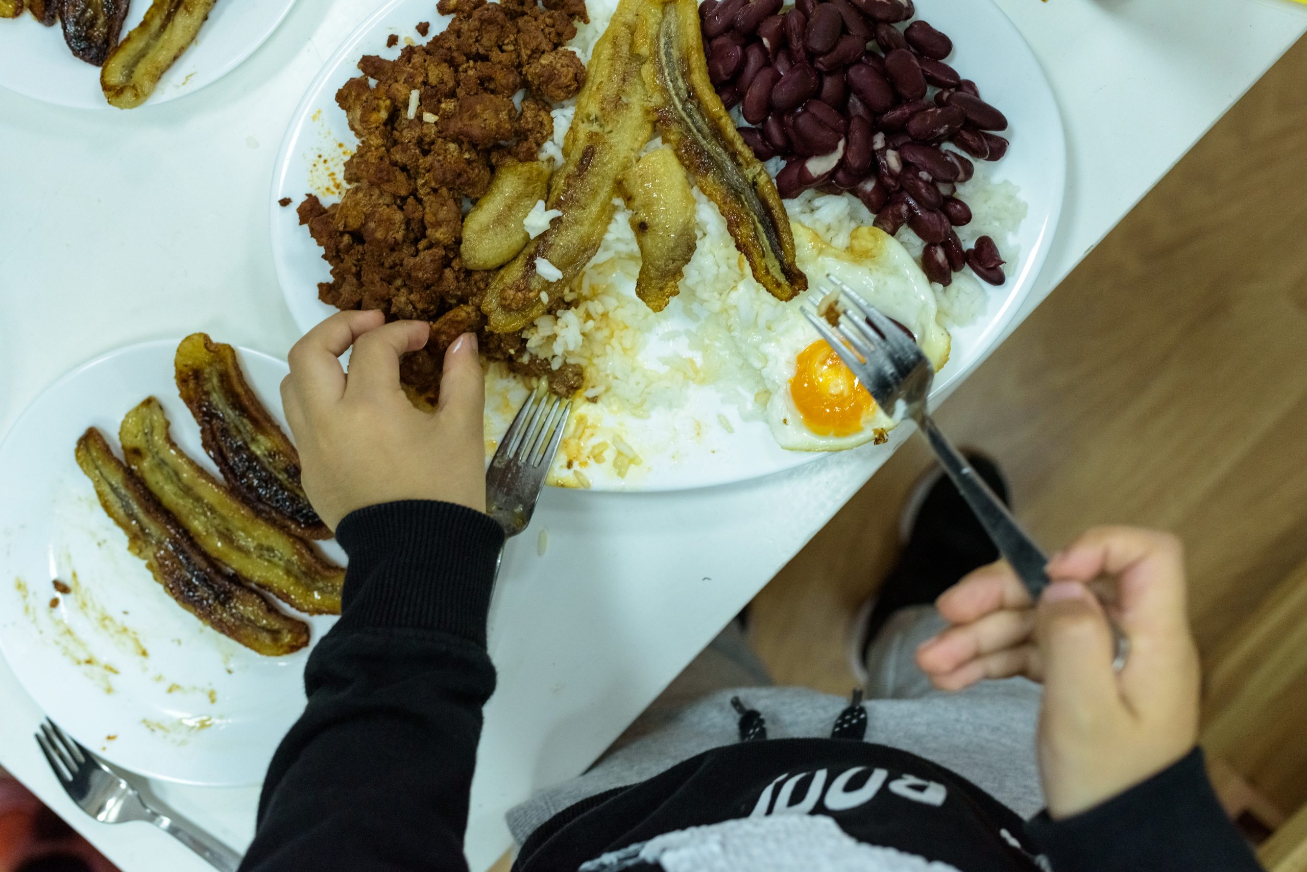 children eating the typical colombian dish bandeja 2024 10 18 09 49 49 utc scaled